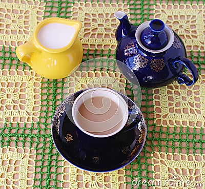 Cup of tea jug with milk and teapot Stock Photo