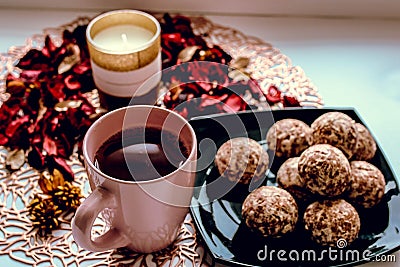 Cup of tea sweets candle and rose petals on the table Stock Photo