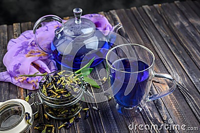 Cup and teapot butterfly pea flower blue tea. Healthy detox herbal drink Stock Photo