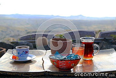 The cup of turkish tea and coffee on the wooden table in the mountains. Stock Photo