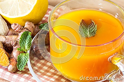 a cup of Turmeric Tea with lemon and ginger , Benefits for reduce Inflammation , Liver Detox and Cleanser healthy herb drink Stock Photo