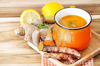 a cup of Turmeric Tea with lemon and ginger , Benefits for reduce Inflammation , Liver Detox and Cleanser healthy herb drink Stock Photo