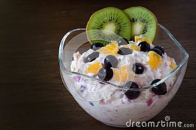 Cup of yogurt with orange and berries Stock Photo