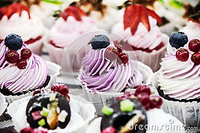 Cupcake cakes with fresh berries on the counter Stock Photo