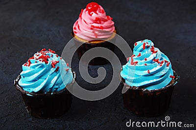 Cupcake cakes pink, blue on a dark background Stock Photo