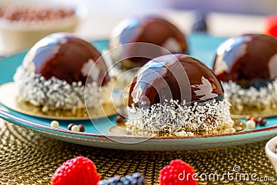 cupcake with chocolate cream. Chocolate round cake with raspberry set on a blue plate.Berry dessert. airy cake souffle Stock Photo