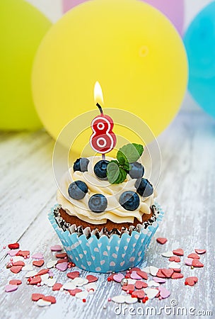 Cupcake with a numeral eight candle Stock Photo