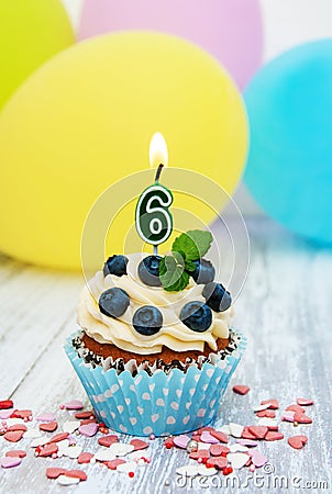 Cupcake with a numeral six candle Stock Photo