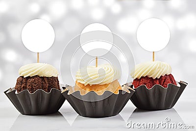 Cupcake Toppers Mockup with Three Gourmet Cupcakes and a Bokeh Patterned Background Stock Photo