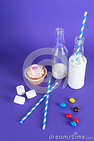 Cupcake for Valentine's Day with hearts on top of whipped cream and milk cocktails with retro cocktail tubes, served in bottles on Stock Photo