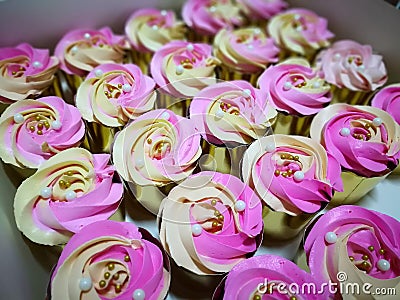 Cupcakes, chocolate beads, icing, creamy Stock Photo