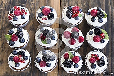 Cupcakes with Fruits on a Rustic Wooden Table Stock Photo