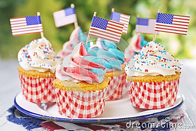 Cupcakes with red-white-and-blue frosting and American flags Stock Photo