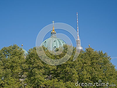 Cupola of Berlin cathedral and Fernsehturm above trees of Lustgarten park Editorial Stock Photo