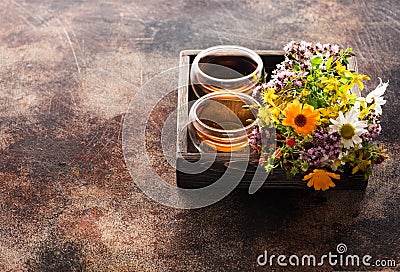 Cups Herbal tea and Healing herbs in a wooden tray Stock Photo