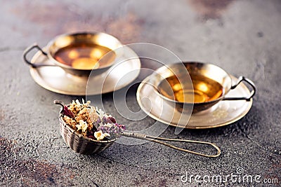 Cups herbal tea and strainer Stock Photo