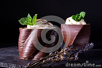 Cups printed on a 3D printer with chocolate, whipped cream and mint leaves Stock Photo