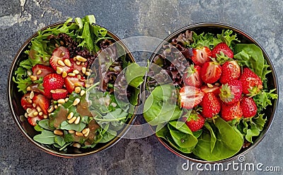 cups of strawberries, assorted greens and pine nuts Stock Photo