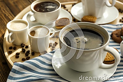 Cups with tasty aromatic coffee and cookies on tray Stock Photo