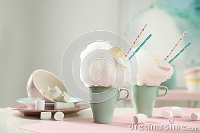 Cups of tasty cotton candy dessert and marshmallow, space for text Stock Photo