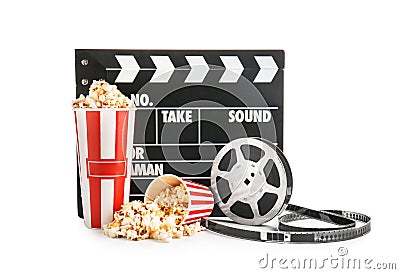 Cups with tasty popcorn, film reel and clapperboard on white background Stock Photo