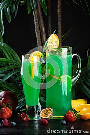 Curacao lemonade in a glass and jug decorated with an orange slice Stock Photo