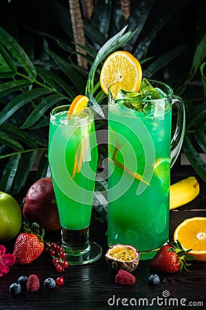 Curacao lemonade in a glass and jug decorated with an orange slice Stock Photo