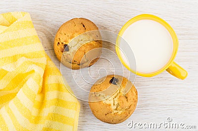 Curd biscuits with raisin, cup of milk, yellow napkin Stock Photo
