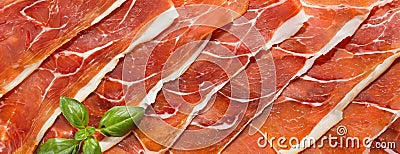 Cured Iberian Ham Slices Arranged Neatly on a Surface. Thinly sliced Iberian ham displays marbled fat and rich color Stock Photo