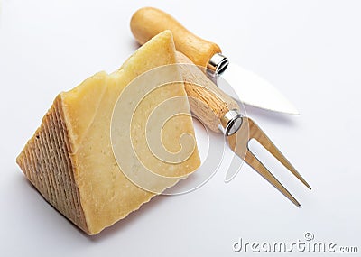Cured sheep cheese Manchego type in wedge and cutlery. Isolate Stock Photo