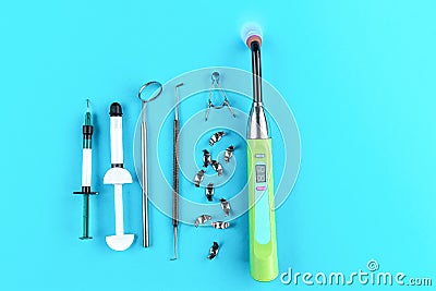 Curing light dental lamp for teeth whitening, composite syringe, metal matrices, mouth mirror, periodontal explorer scaler Stock Photo