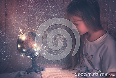 Curious admiring kid girl with book in bed dreaming about space and universe concept astronomy curiosity knowledge education deve Stock Photo