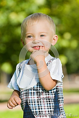 Curious baby boy in the summer park Stock Photo