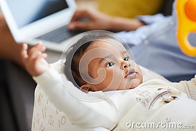 Curious baby in cocoon looking around Stock Photo