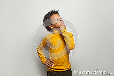 Curious black child looking up on white background Stock Photo