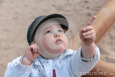 Curious boy, pointing with finger upwards Stock Photo