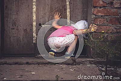 Curious child looking into dark hole in barn door in countryside shed concept curiosity Stock Photo