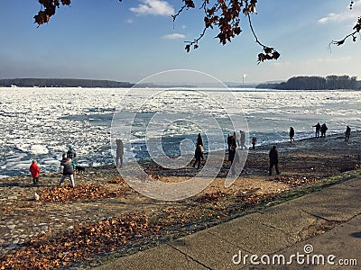 Curious crowd looking at the icebergs covering the vast Danube r Editorial Stock Photo
