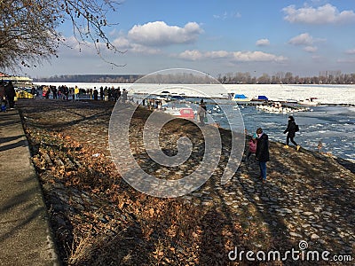 Curious crowd looking at the icebergs floating on the Danube riv Editorial Stock Photo