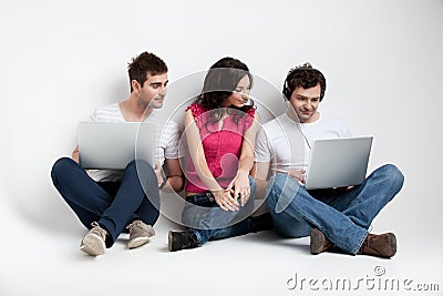 Curious friends looking at laptop Stock Photo