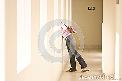 Curious girl looking out window Stock Photo