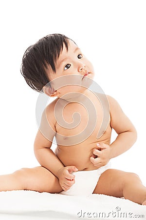 Curious Infant child baby toddler sitting and look up Stock Photo