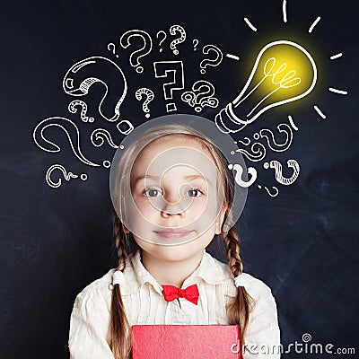 Curious kid of school age with lightbulb and chalk question mark Stock Photo