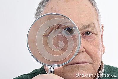 Curious man peering through magnifying Stock Photo