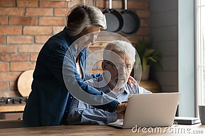 Curious mature man enjoying learning modern tech gadget usage. Stock Photo