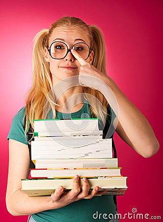 Curious, naughty, playful schoolgirl with stack of books and big Stock Photo