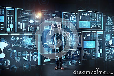 Curious programmer standing in front of a screen in virtual reality glasses Stock Photo