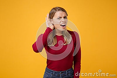 Curious shocked young blonde woman girl in casual clothes posing isolated on yellow orange background studio portrait Stock Photo