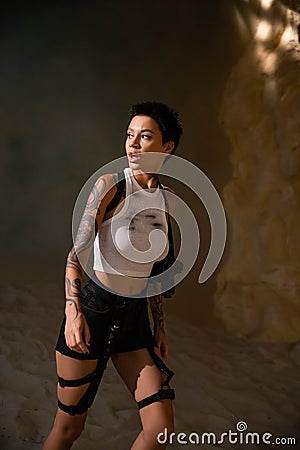 curious and tattooed archaeologist in sexy Stock Photo