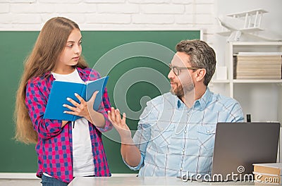 curious teen girl and teacher man in high school with workbook and pc at blackboard, communication Stock Photo